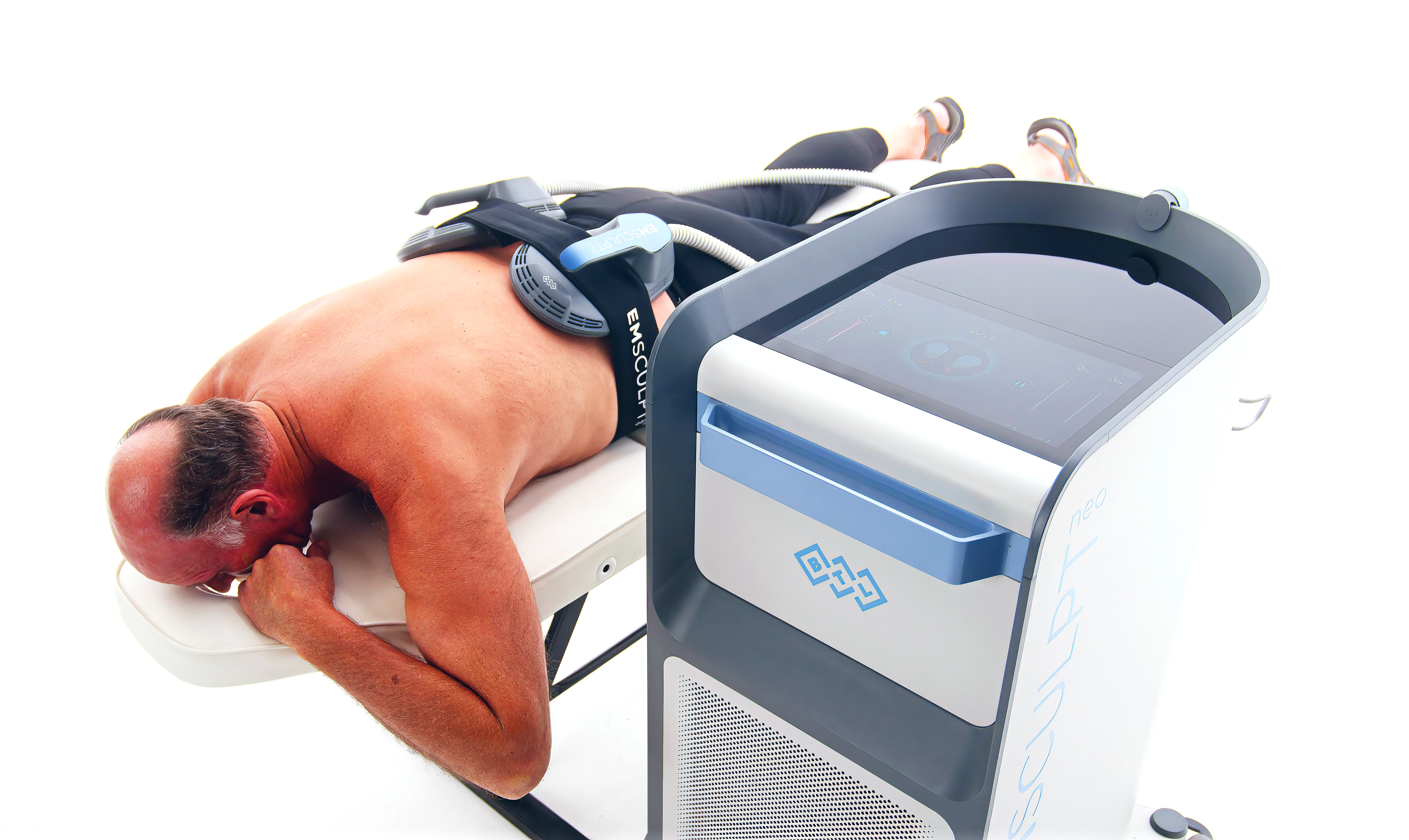 Emsculpt Neo male treatment on back with large applicator