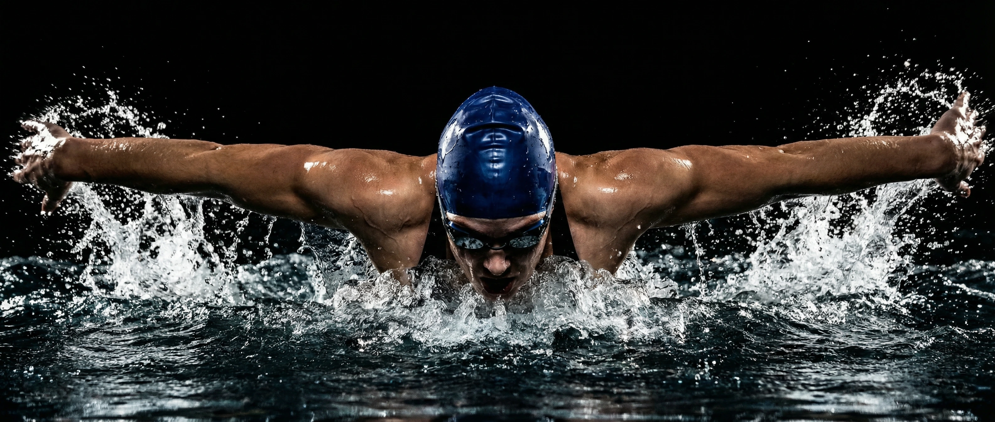 Competitive swimmer performing butterfly stroke showcasing athletic performance enhanced by regenerative PRP therapy